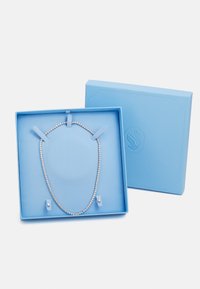 Rhinestone ketting tentoongesteld in een lichtblauwe gestructureerde cadeau-doos met verwijderbare ondersteuning. De doos heeft een logo-ontwerp op de deksel.