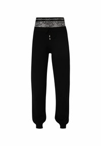 Czarne dresy z koronkowym akcentem w pasie i regulowanym sznurkiem. Posiadają zwężane nogawki i elastyczne mankiety dla dopasowanego kroju.