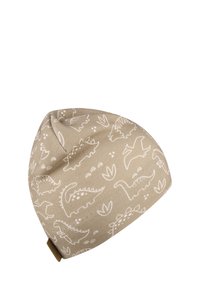 Beige beanie with dinosaur patterns in white. Soft fabric, tapered shape, and a small brown accent at the back. Suitable for casual wear.