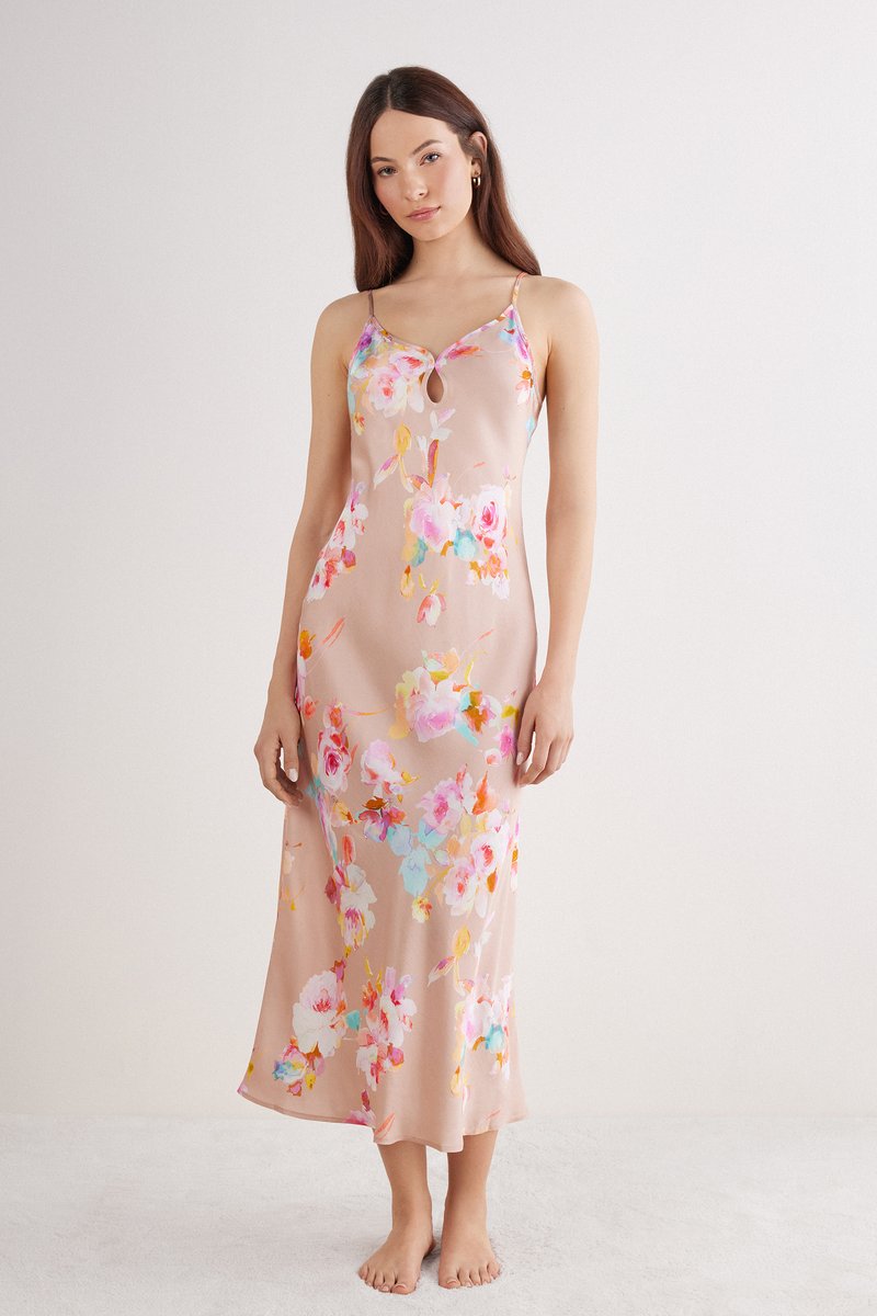 Floral slipdress in lichtroze, met een keyhole-halslijn, verstelbare bandjes en een vloeiende silhoeet met kleurrijke bloemenpatronen.