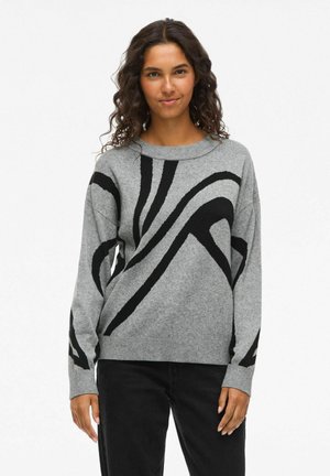 Pull gris avec motif abstrait en vagues noires, col rond, poignets et ourlet côtelés. Fabriqué à partir d'un tissu doux au toucher texturé.