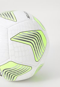 White soccer ball with textured surface, featuring neon green accents and black stripes. Distinct geometric design elements on panels.