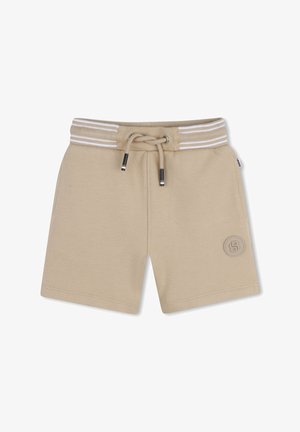 Shorts beiges en tissu texturé, dotés d'une taille à cordon, de rayures blanches et d'un logo cousu sur le côté inférieur droit.