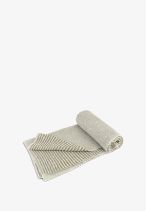 Couverture roulée en tissu gris avec une texture côtelée. Un côté est uni, tandis que l'autre présente des rayures alternées dans des teintes plus claires et plus foncées.