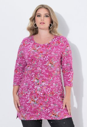Lange mouwen roze tuniek versierd met witte en kleurrijke bloempatronen, met een ronde halslijn en een licht gebogen zoom.