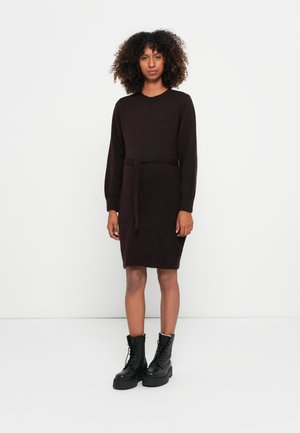 Knit dress in dark burgundy, long sleeves, crew neckline, cinched waist with a tie belt, paired with black lace-up ankle boots.