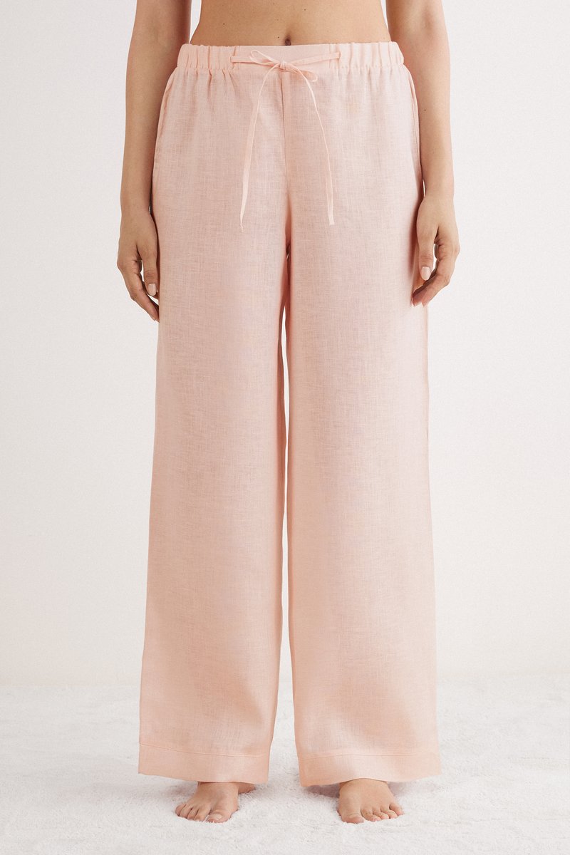 Lichtroze linnen broek met een wijde pijp, elastische tailleband en verstelbaar trekkoord. Glad textuur met een ontspannen pasvorm.