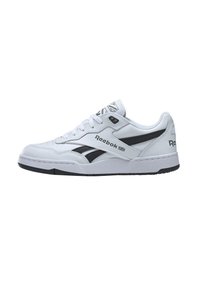 White athletic shoe with black accents, synthetic leather upper, laced closure, padded collar, and textured rubber sole. Features Reebok logo.