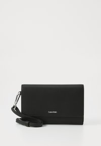 Black leather wallet with a smooth texture, flap design, and silver hardware. Features a detachable strap and embossed logo detail.