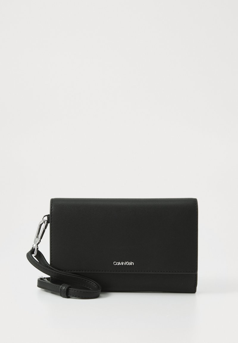 Black leather wallet with a smooth texture, flap design, and silver hardware. Features a detachable strap and embossed logo detail.