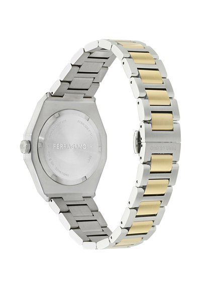 Ferragamo rozsdamentes acél karóra aranyszínű szemekkel, hatszögletű hátlappal és gravírozott márkanévvel a csaton és a hátlapon.