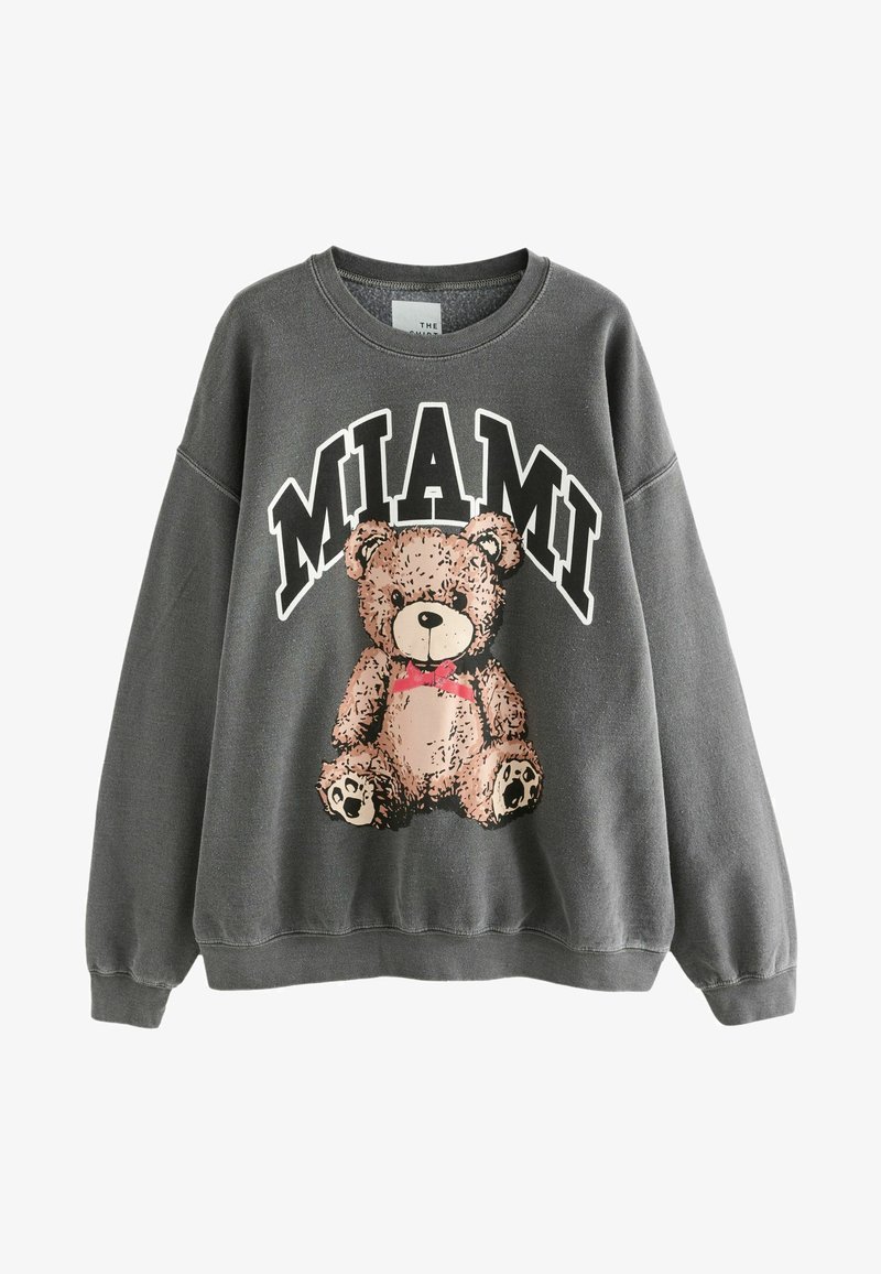 Sweatshirt gris avec un col rond arborant un motif de ours en peluche. Texte "MIAMI" au-dessus de l'ours. Tissu doux avec des poignets et un ourlet à côtes.