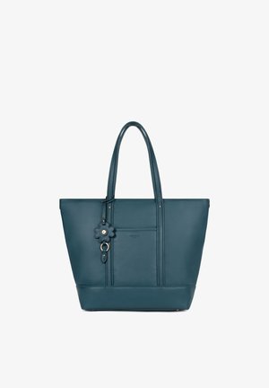 Sac fourre-tout en cuir bleu sarcelle avec double poignées et un porte-clé en forme de fleur suspendu à une des poignées sur fond blanc.