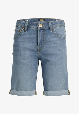 Biała koszulka z krótkim rękawem z nadrukowanym logo, zestawiona z podwiniętymi szortami jeansowymi i beżowymi trampkami, do tego białe skarpetki z elementami logo.