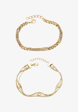 Kullanväriset rannekorut, joissa on näyttävä linkkisuunnittelu ketjunkuvioinnilla ja sileä ovaali korostus kaarevalla nauhalla, kerroksellisessa tyylissä.