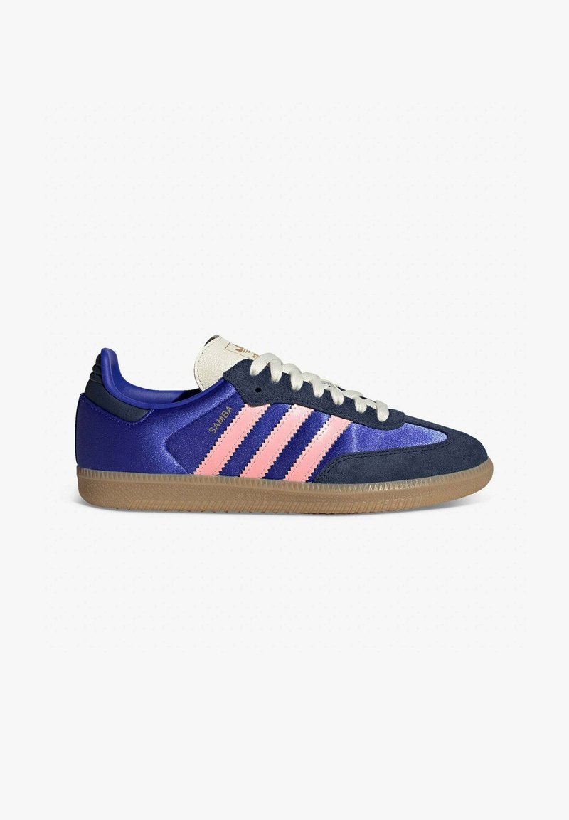 Blue and pink Adidas Samba sneaker, featuring a textured suede toe, satin upper, and a gum rubber sole with three pink stripes on the side.