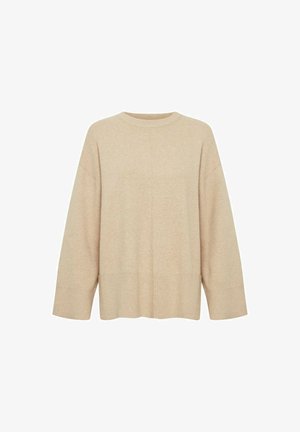 Beige oversized sweater met lange mouwen, ronde hals en een zachte textuur. Heeft een naaddetail dat verticaal over de voorkant loopt.
