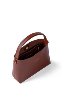 Brown leather handbag with a structured design, top handle, and magnetic closure. Interior features zip pocket and multiple compartments.