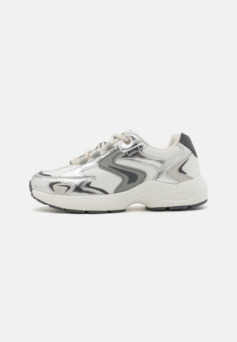 Sneakers in white and silver with mesh and synthetic materials. Rounded toe, padded collar, thick sole, and curved design accents.