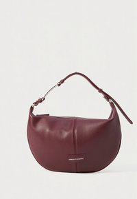 Borsa a mano in pelle bordeaux con forma curva, tracolla corta, dettagli in argento e accento con logo. Presenta una chiusura con zip per maggiore sicurezza.