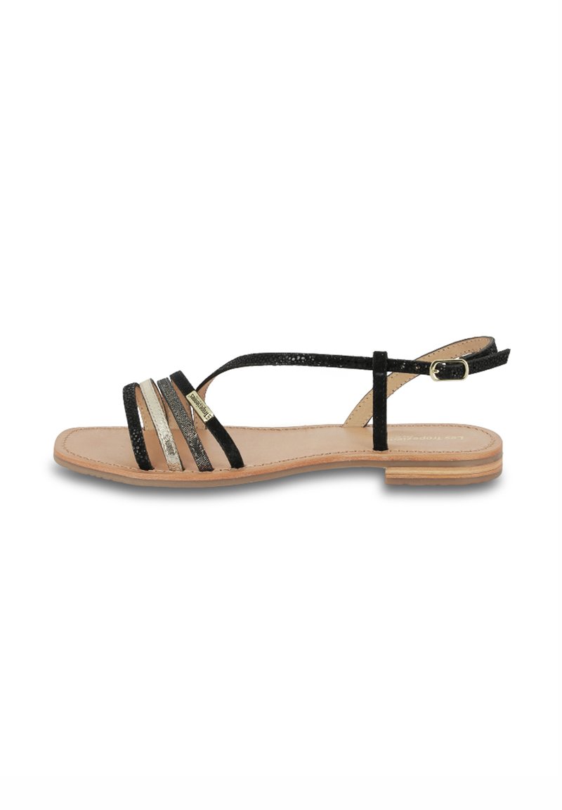 Sandali piatti neri con più cinturini orizzontali, inclusi dettagli glitterati. Presentano una soletta in pelle naturale e un tacco basso.