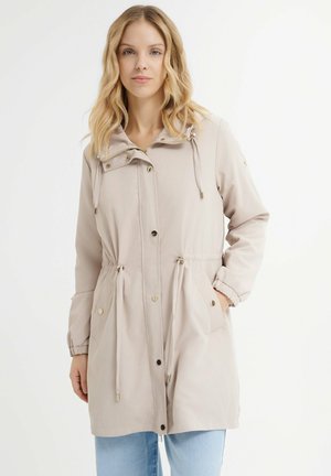 Veste à capuche beige clair avec taille à cordon de serrage, boutons-pression à l'avant et deux poches latérales. Tissu lisse avec des poignets de manches élastiques.