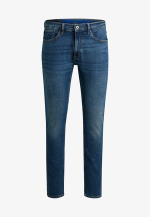Donkerblauwe denim jeans met een vervaagd effect, voorzien van een rits, vijf zakken en een merkband in de taille. Slanke pasvorm.