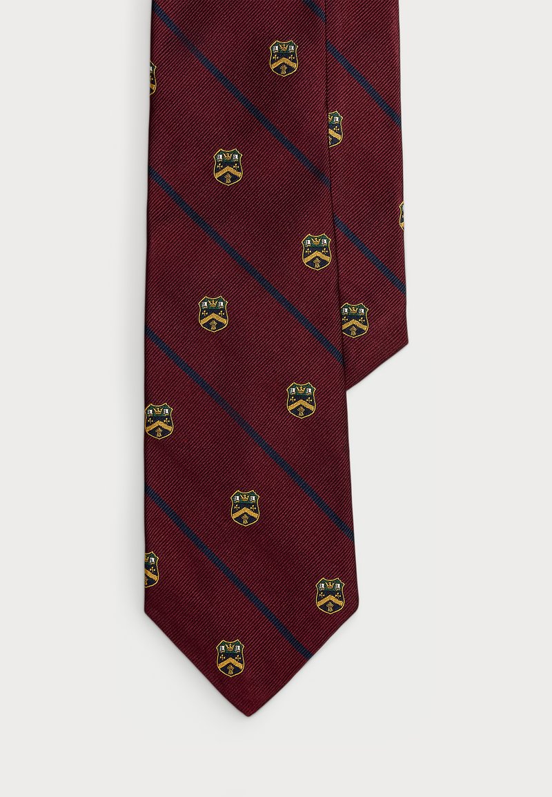 Corbata burdeos con un patrón diagonal de líneas azules y pequeños diseños de cresta amarilla y negra. Tejido texturizado con punta afilada.