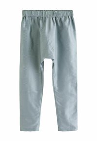 Pantalons bleu clair texturés avec une taille élastique et un design à jambe droite. Ils présentent un motif en losange subtil sur l'ensemble.