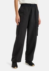 Black cargo pants with an elastic waistband, side pockets, and a loose fit. Made of lightweight fabric with minimal stitching details.