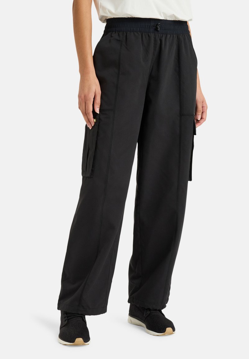 Black cargo pants with an elastic waistband, side pockets, and a loose fit. Made of lightweight fabric with minimal stitching details.