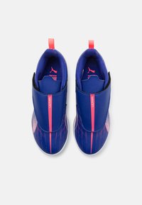 Blue athletic shoes with a sleek design, featuring pink accents, a textured surface, and elastic closures, ideal for active wear.