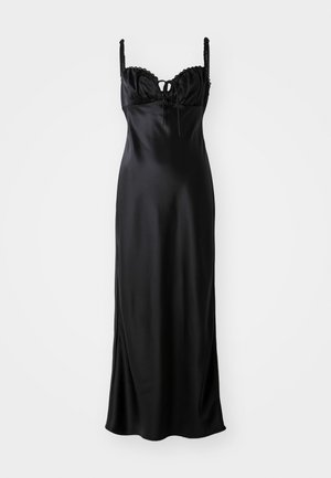 Black satin maxi dress with a fitted bodice, scalloped lace trim, adjustable spaghetti straps, and a front tie detail.