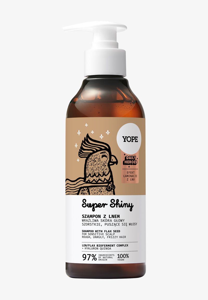 Flacon en verre ambré avec un distributeur à pompe blanc, doté d'une étiquette marron avec des illustrations noires. Le texte comprend "Super Shiny" et les détails du produit.