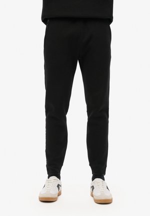 TECH LOGO TAPERED - Træningsbukser - black