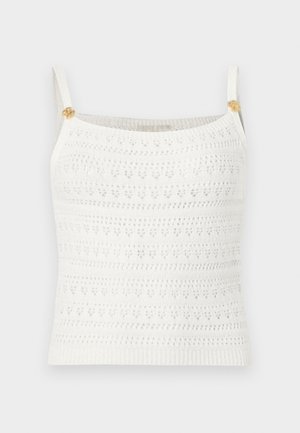 Witte gebreide, mouwloze cropped top met dunne bandjes en kleine gouden knopen in de vorm van bloemen op elk bandje.