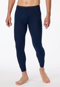 Sous-vêtements longs bleu marine en tissu doux et extensible avec un design ajusté, comprenant une poche fermée et des poignets côtelés.