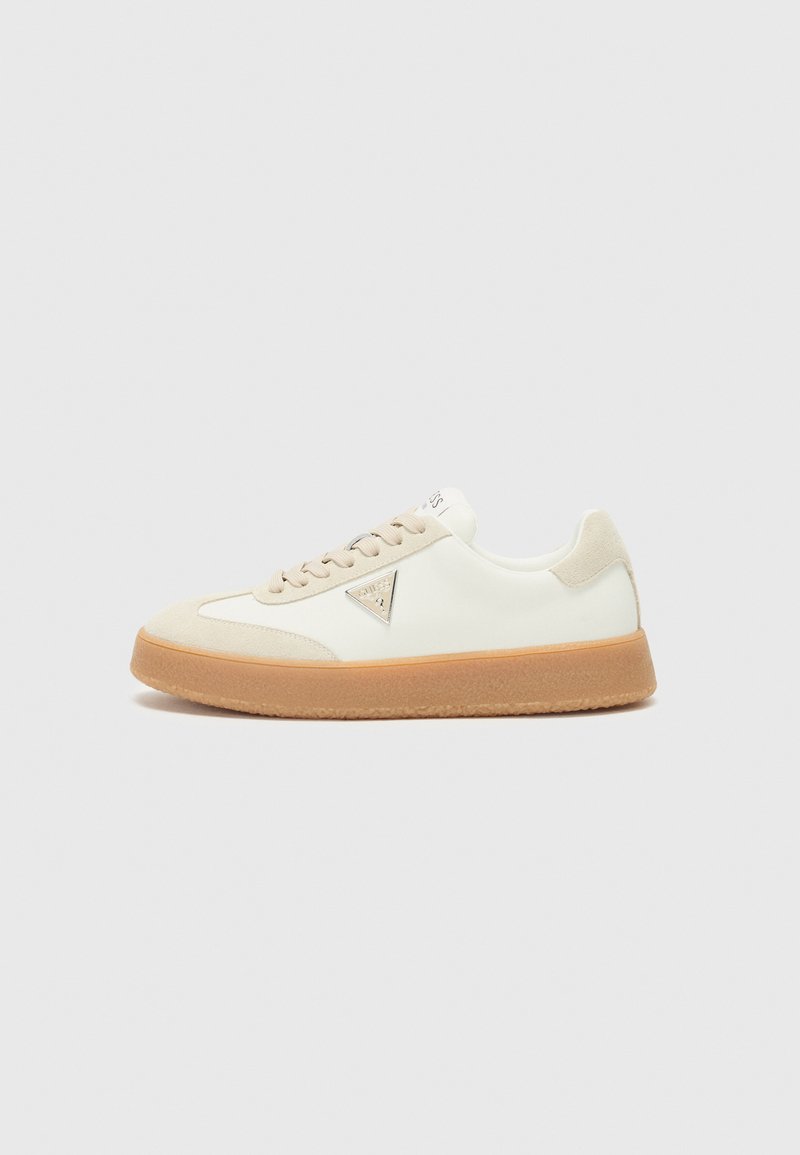 White sneaker with beige accents, suede and leather materials, rounded toe, rubber sole, and a triangular logo detail on the side.