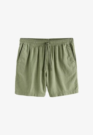 Shorts à carreaux verts clairs avec une ceinture élastique, un cordon de serrage et des poches latérales, présentés sur un fond blanc.