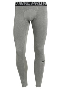 Graue Sportleggings mit einem schwarzen "Nike Pro"-Bund, die eine schmale Passform, eine glatte Textur und kontrastierende hellgraue Seiteneinsätze aufweisen.