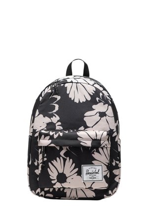 Zaino nero con grande stampa floreale bianca, dotato di tasca frontale, patch con logo e chiusura a doppia zip, realizzato in materiale resistente.