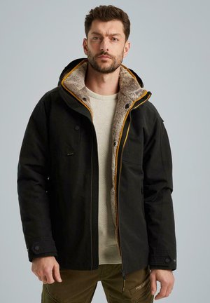 Black jacket with a fur-lined hood and yellow accents, featuring zip and button closures, two chest pockets, and ribbed cuffs.