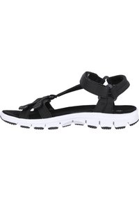 Black fabric sandal with adjustable straps, a cushioned footbed, and a white rubber sole featuring a textured tread pattern.
