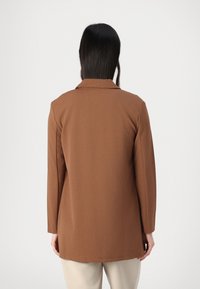Brown long-sleeve blazer with a collar and slightly tapered shape, made of smooth fabric, featuring a straight hem and minimalistic design.