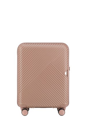 Hard-shell suitcase in light pink with diagonal ribbed texture, rounded corners, and four spinner wheels for mobility. Rose gold hardware accents.