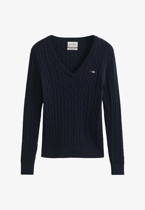 Tengerészkék, kötött pulóver V-nyakkivágással, bordázott mandzsettákkal és szegéllyel. A GANT logó hímzéssel díszített a mellrészen. Strukturált anyagból készült.