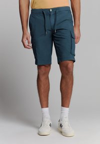 Teal cargoshorts met een koord en knoopsluiting, voorzien van zijzakken en een relaxte pasvorm. Gemaakt van lichte stof.
