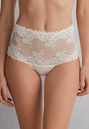 White lace bikini-style underwear featuring floral patterns, a semi-sheer mesh design, and a scalloped lace waistband.