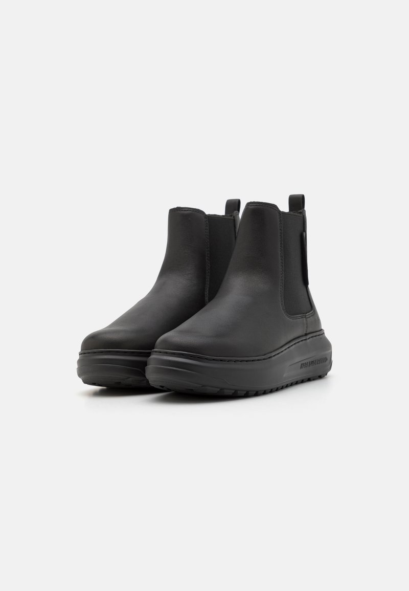 Schwarze Lederstiefeletten mit elastischen Seitenteilen, abgerundetem Zeh und einer gepolsterten Sohle mit strukturiertem Profil für guten Halt.