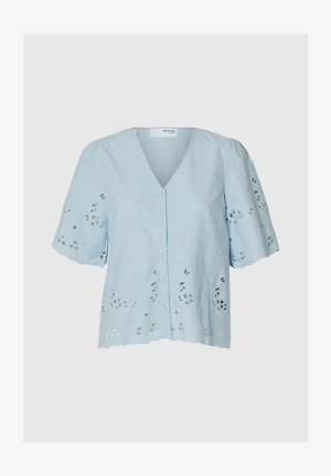 Light blue blouse with a V-neck, short puff sleeves, and floral embroidery. Features button front and cut-out detailing along the hem.